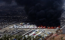 Photo by Karl-Ludwig Poggemann / CC BY 2.0 Cars burn in Tianjin after the explosion