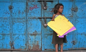 Photo by Meena Kadri / CC by-SA 2.0 Yellow Patang. A girl from the nearby slum collecting fallen kites (patang) at Manek Chowk in the Old City.