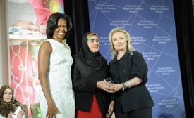 Photo reprinted courtesy U.S. Department of State via Flickr Secretary Clinton and First Lady Obama IWOC by U.S. Department of State