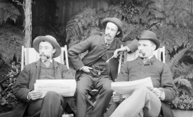 Photo reprinted courtesy State Library Victoria Collections, via Flickr Three men sitting in deckchairs, smoking pipes and reading papers.