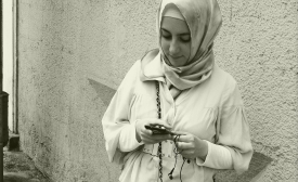 Photo reprinted courtesy Spoxx, via Flickr A young woman checks her smart phone