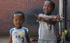 Photo reprinted courtesy Thomas Sly, via Flickr https://flic.kr/p/8LTno Young boys at a market in Cape Town, South Africa