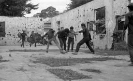 Photo reprinted courtesy Linda Hess Miller, via Wikimedia Commons Guerrilla fighters playing soccer in El Salvador, late 1980s