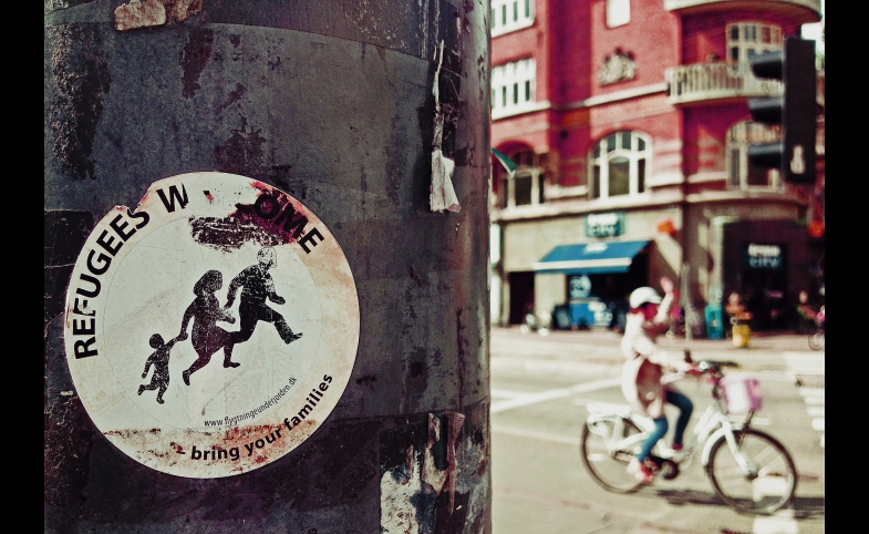 Photo reprinted courtesy of Raven Hawks via Flickr Refugees Welcome, by Raven Hawks