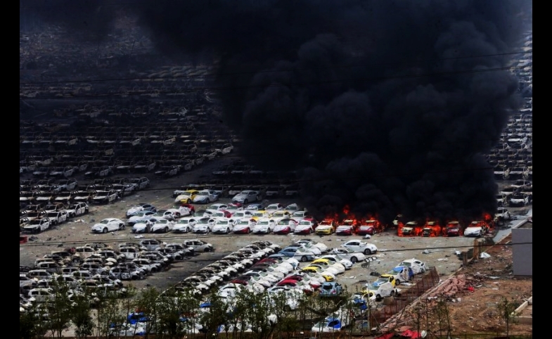 Photo by Karl-Ludwig Poggemann / CC BY 2.0 Cars burn in Tianjin after the explosion