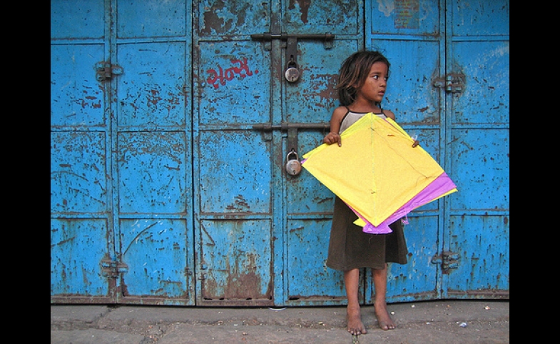 Photo by Meena Kadri / CC by-SA 2.0 Yellow Patang. A girl from the nearby slum collecting fallen kites (patang) at Manek Chowk in the Old City.