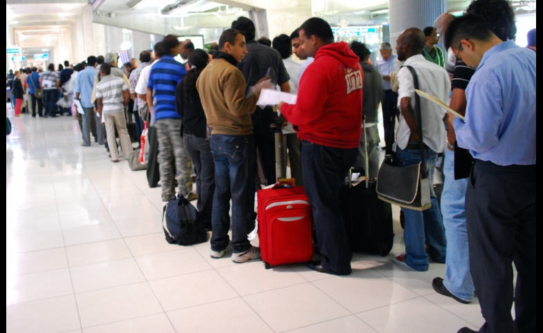 Photo reprinted courtesy Harsha K R, via Flickr https://flic.kr/p/7C1z3b Travelers to Bangkok wait on line for visas