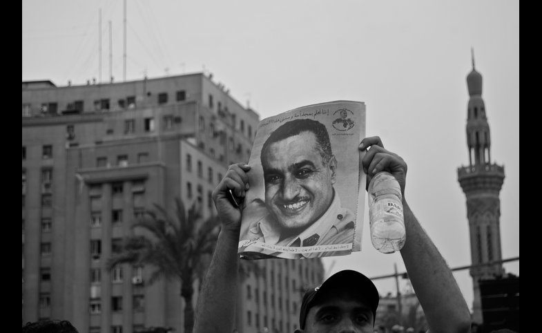 Photo reprinted courtesy Sarah.249, via Flickr A protestor in Tahrir Square, Cairo, holds up a portrait of former President Nasir, 2011