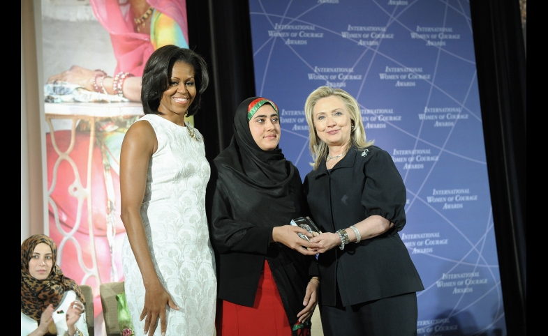 Photo reprinted courtesy U.S. Department of State via Flickr Secretary Clinton and First Lady Obama IWOC by U.S. Department of State