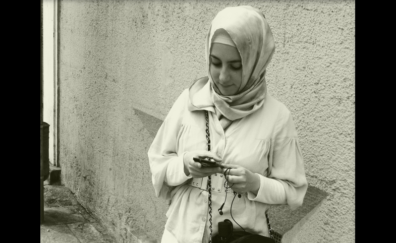 Photo reprinted courtesy Spoxx, via Flickr A young woman checks her smart phone