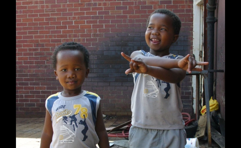Photo reprinted courtesy Thomas Sly, via Flickr https://flic.kr/p/8LTno Young boys at a market in Cape Town, South Africa